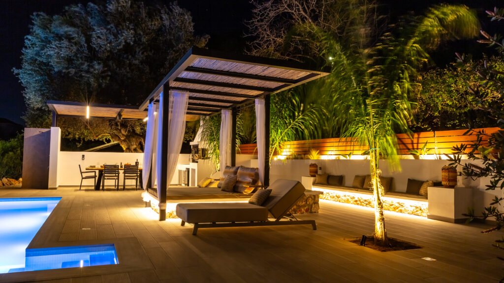 Day bed, pool and outside dining at night 5